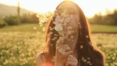 Beautiful Young Woaman Blowing Dandelion Laughing on a Summer Field HD