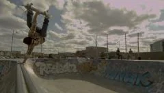 Skateboarding Bowl Handplant on a Graffiti Covered Quarter pipe in a skatepark