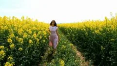 Young Woman in Vintage Dress Walking on Path Yellow Flowers Spring Field HD