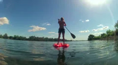 SUP SEXY FIT WOMAN ON SUP STAND UP PADDLE BOARD BOARDING ON LAKE