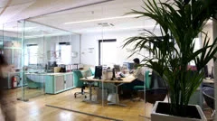 Time lapse of attractive young professionals at work in busy modern office