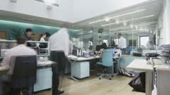 Time lapse of creative young professionals at work in busy modern office