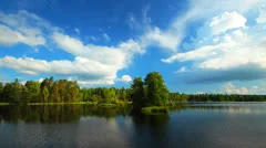 Summer nature, forest lake landscape with sky and clouds, time-lapse.