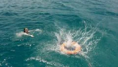 lifeguard rescuing drowning girl