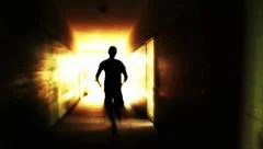 Silhouette man running light in a tunnel escape freedom concept
