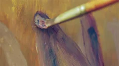 close up of a brush that paints a canvas - painter