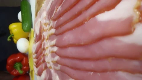 03 bacon strips fall on the cutting board vertical close up Stock Footage 221127124