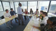Mixed ethnicity business group in boardroom meeting or training seminar