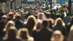 Anonymous crowd of people walking on New York City street slow motion backlit