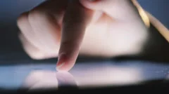 closeup finger touching tablet computer touchscreen