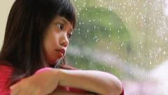 Little Asian Girl Depressed On A Rainy Day