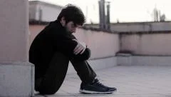 Abandoned, alone, sad, depressed young man. Tracking camera