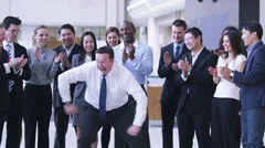 Funny dancing businessman.  Excited group of business people clap their strange