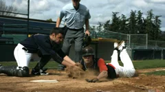 Baseball player slides into home plate, slow motion