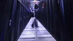 People working in computer server room data center. Walking along rows of super