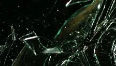 Glass shatters and falls, slow motion