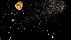 Floating Lanterns in the Night Sky During Yee Peng Festival in Thailand