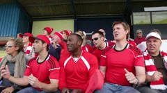 Boy with family in crowd of sports spectators. Could be a stadium crowd at the