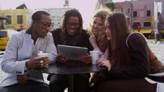 Group of friends looking at digital tablet together