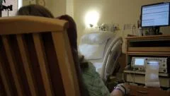 Woman in hospital room with medical equipment
