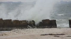 Waves crashing over a seawall 8