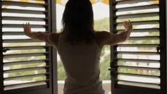 Girl opens the door in the morning and go out to the terrace HD