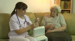 Home health care doctor & old asthmatic patient, inhaler, respiratory diseases