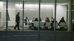 Diverse business team in late night boardroom meeting in contemporary office