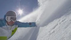 SLOW MOTION: Snowboarder hand drag