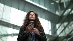 Attractive young woman using her mobile device for directions