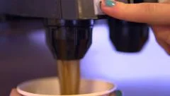 Child filling cup at soda fountain