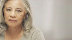 Older black woman with gray hair looking at camera