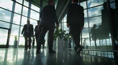 Time lapse of business people and clouds in a light and modern office building
