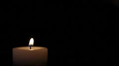 Shot of a candle burning, isolated on black background