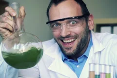 Crazy, mad scientist laughing in laboratory, super slow motion, shot at 240 NTSC