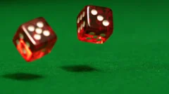 Red dice rolling on casino table