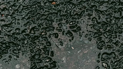 036_Wet asphalt texture with abstract patterns.mp4 Stock Footage 345726331