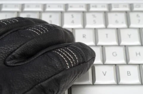 Hacking concept with hand in black leather glove over the laptop ...