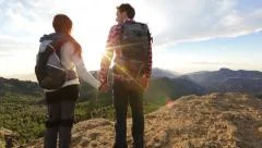 Couple holding hands hiking outdoors