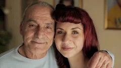 senior man and young girl smiling together. video filmed in close-up