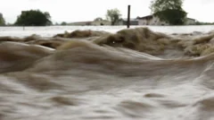 Waves close up. Flood river destroyed agricultural field after big rain storm.