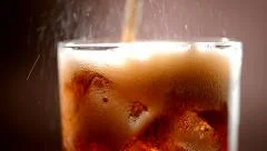 Cola with ice and bubbles in glass. Slow motion 240 fps. Full HD 1080p