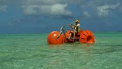Man on Unusual funny pedalo on beautiful sea clear paradise water beach resort.