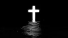 Shining cross in black water.