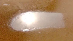 Water puddle absorbed by sand