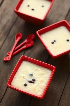 three  red  bowls  of  the  ecuadorian  dessert  called  morocho  (coarsely  ground  white  corn)  cooked  with  milk,  sugar  and  spices  (cinnamon  and  allspice),  similarly  to  rice  pudding  (selective  focus,  focus  into  the  middle  of  the  lower  bowl) xkwx allspice,  bowl,  cinnamon,  coarse,  condiment,  cooked,  corn,  dessert,  ecuador,  ecuadorian,  food,  ground,  jamaica  pepper,  kernel,  maize,  milk,  morocho,  newspice,  porridge,  prepared,  pudding,  red,  spice,  sweet,  traditional,  vertical,  white,  south,  latin,  america,  american,  specialty
