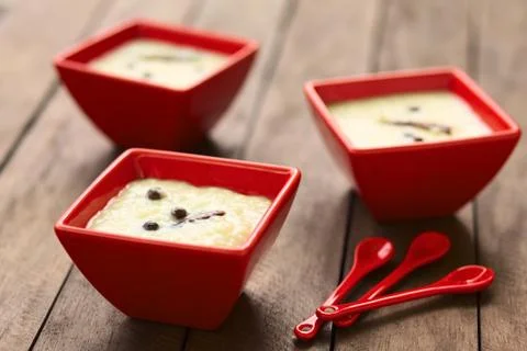 three  red  bowls  of  the  ecuadorian  dessert  called  morocho  (coarsely  ground  white  corn)  cooked  with  milk,  sugar  and  spices  (cinnamon  and  allspice),  similarly  to  rice  pudding  (selective  focus,  focus  on  the  middle  of  the  lower  morocho) xkwx allspice,  bowl,  cinnamon,  coarse,  condiment,  cooked,  corn,  dessert,  ecuador,  ecuadorian,  food,  ground,  horizontal,  jamaica  pepper,  kernel,  maize,  milk,  morocho,  newspice,  porridge,  prepared,  pudding,  red,  spice,  sweet,  traditional,  white,  south,  latin,  america,  american,  specialty
