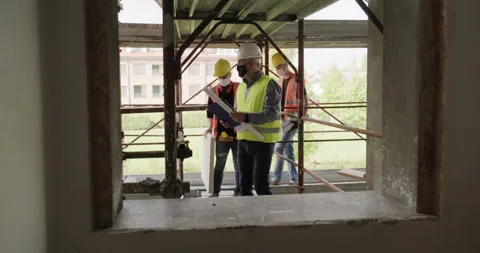 04 Team Of Construction Workers Working In New Building Stock Footage 162833426