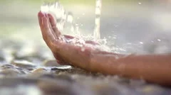 Slow-Mo: Crystal Clear Water Flowing Into A Woman's Hand