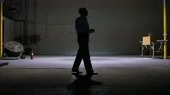 man in a warehouse talking on a cell phone 4k